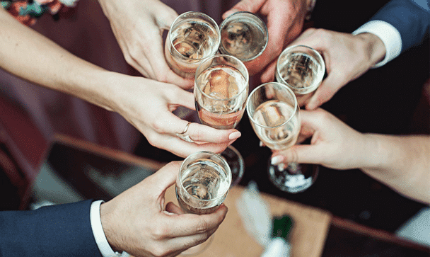 Hands raising glasses in a toast