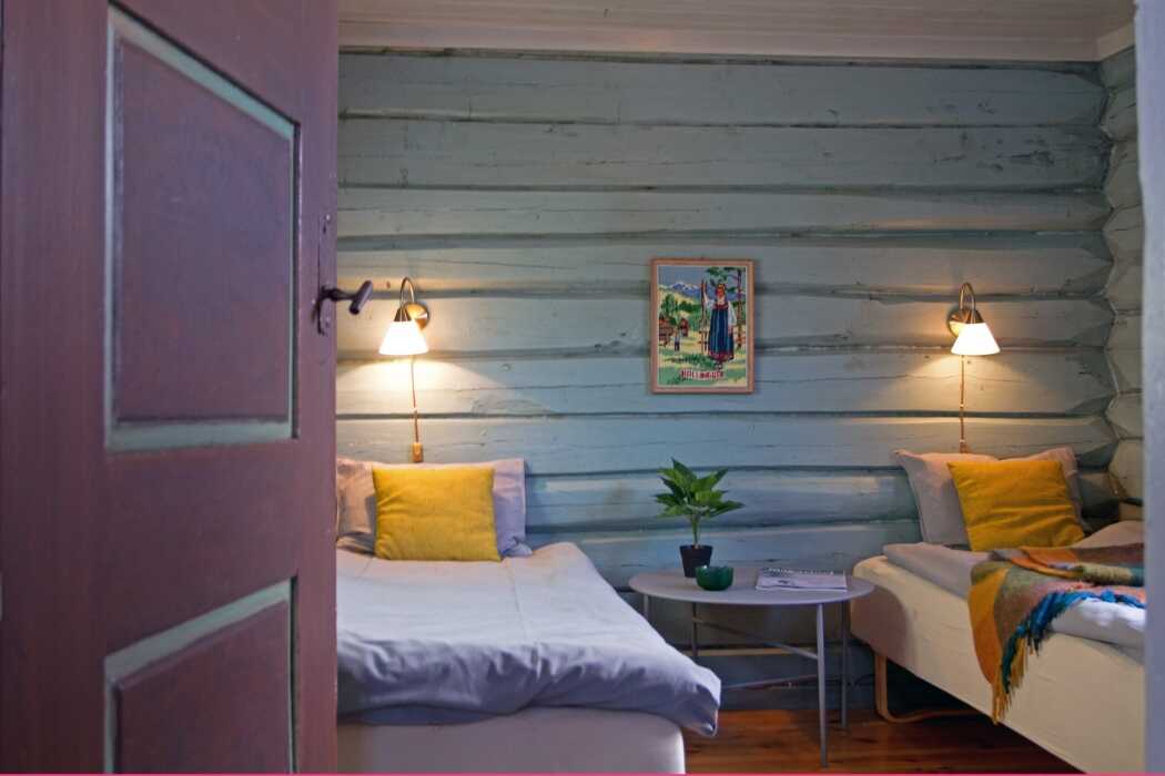 A bedroom with log walls and yellow cushions