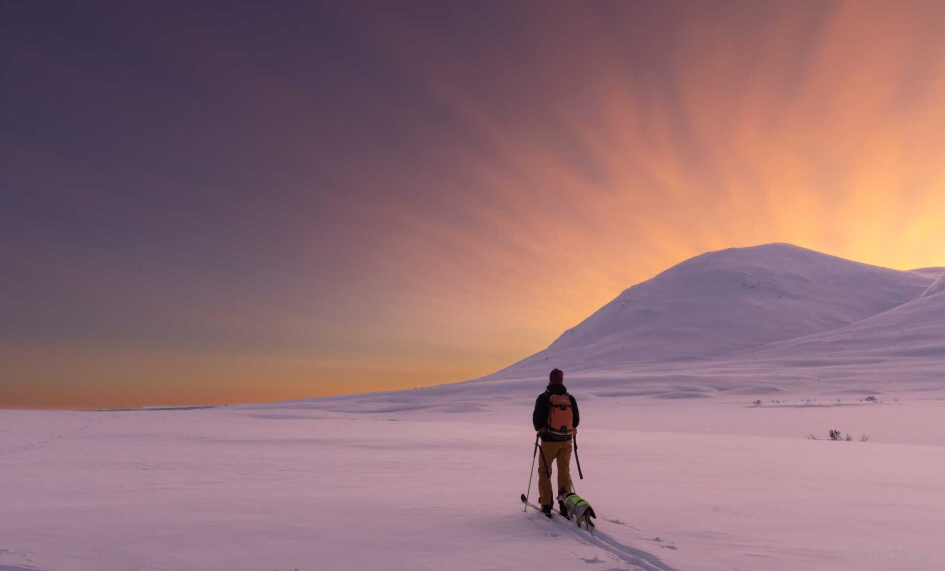 A lone skier crossing the plateau at sunset