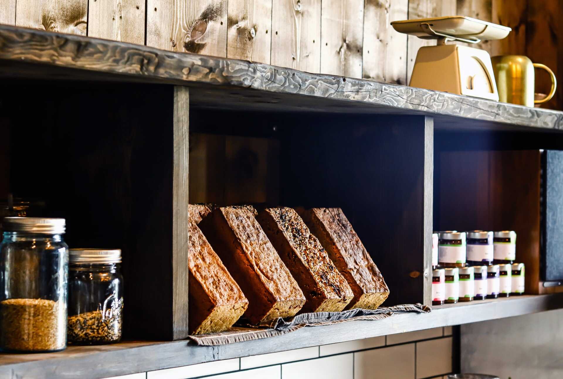 Shelves of jars, cured meat and bread in the farm shop at Huso Lodge