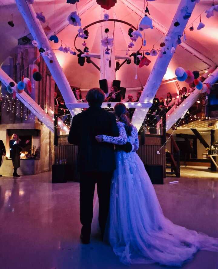 A couple dancing under blue stage light